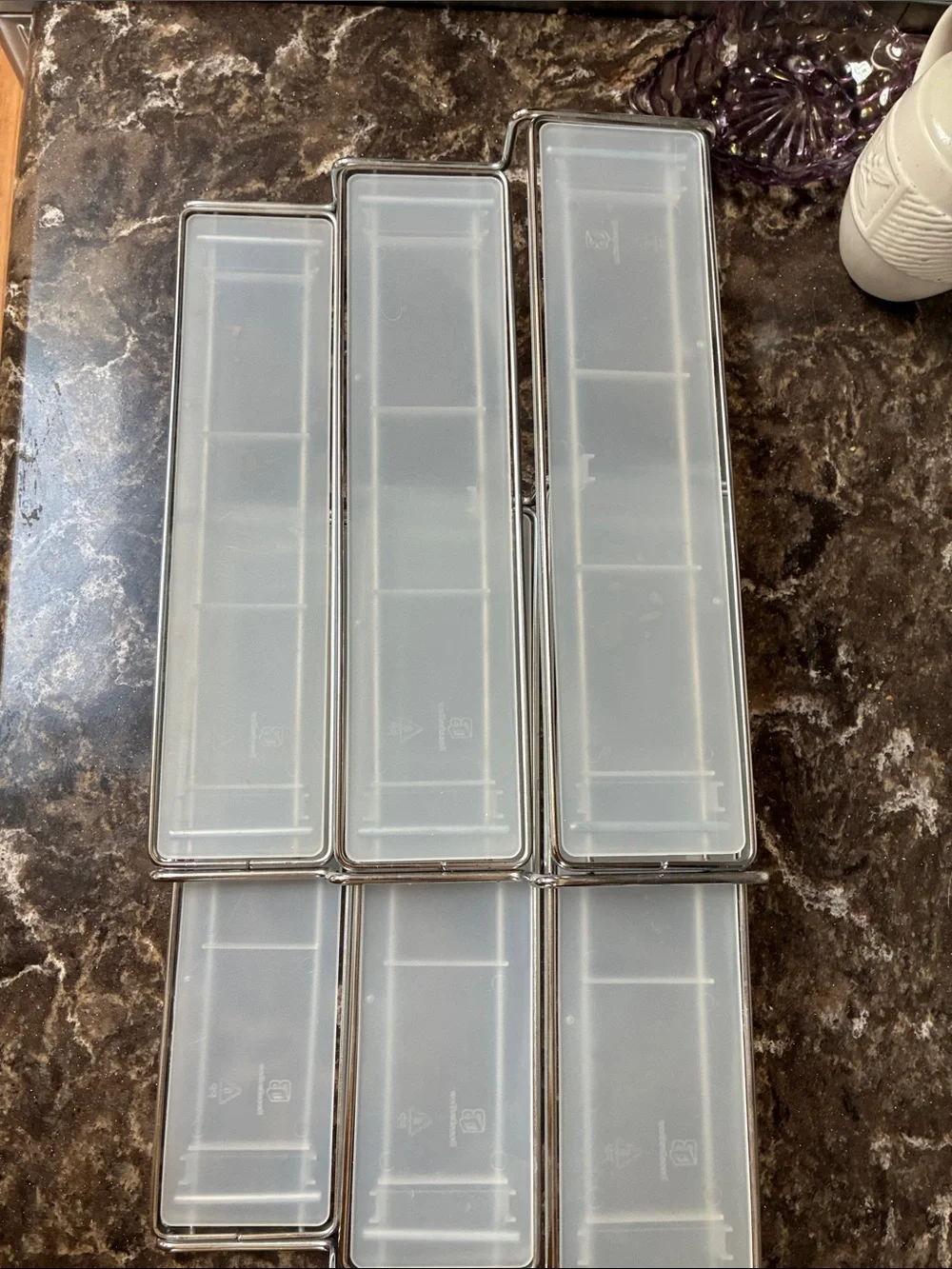 Clear plastic & metal display shelves slide together